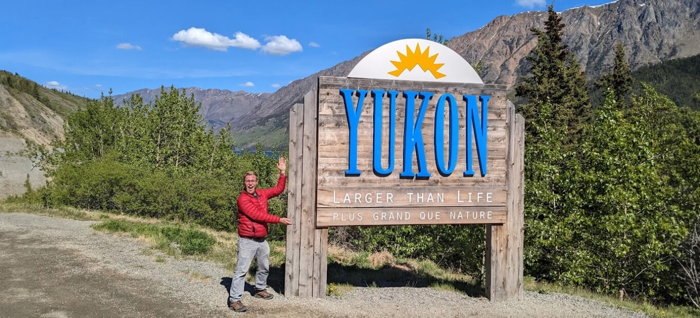 Chris, a person living with obstructive sleep apnea, standing in front of a Yukon sign