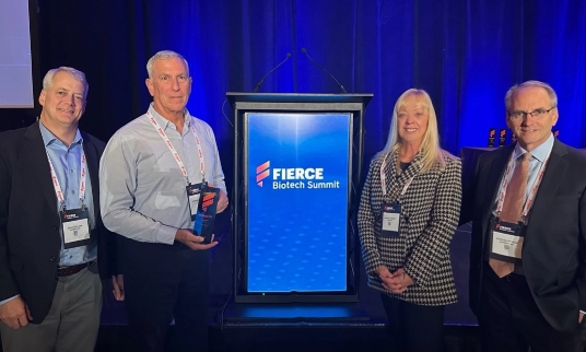 Four employees standing with an award at the Fierce Biotech Summit