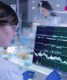 A scientist in a lab looking at a computer screen