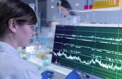 A scientist in a lab looking at a computer screen